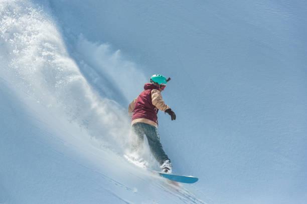 istock Snowboard rider making a turn in powder snow 1055919396