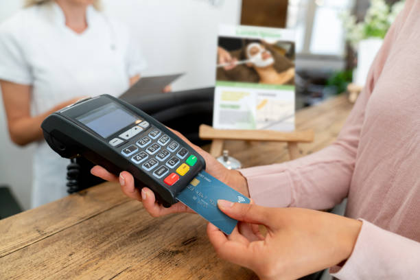 istock Close-up on a woman at a spa paying by card 1055919984