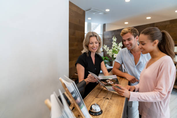 istock Happy clients talking to the manager at the spa 1055919996