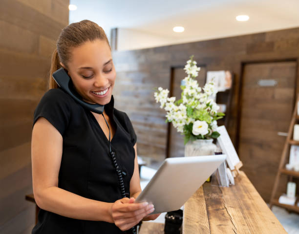 istock Woman working at a spa talking on the phone 1055920162