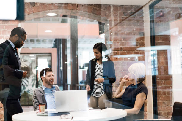 istock Multi-ethnic colleagues discussing in board room 1055920810
