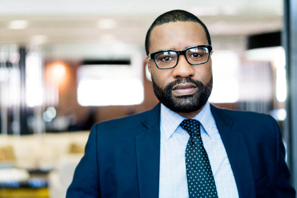 istock Confident businessman in suit standing at office 1055922184