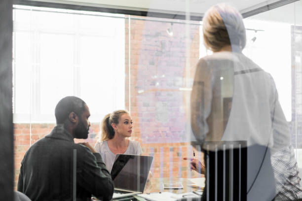 istock Professionals discussing in board room at office 1055923136