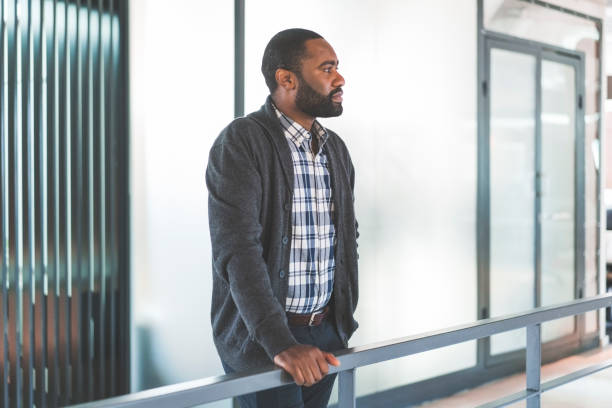 istock Thoughtful businessman standing in corridor 1055923302