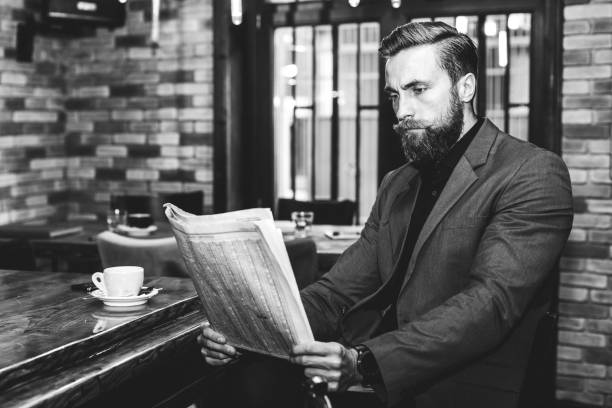 istock Businessman sitting at the bar and reading newspapers 1055923628