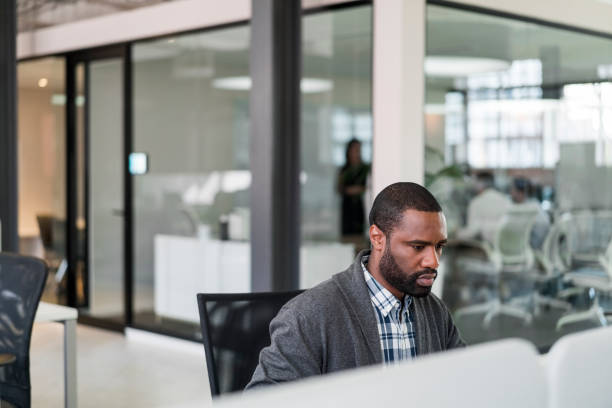 istock Confident businessman working at desk in office 1055923932