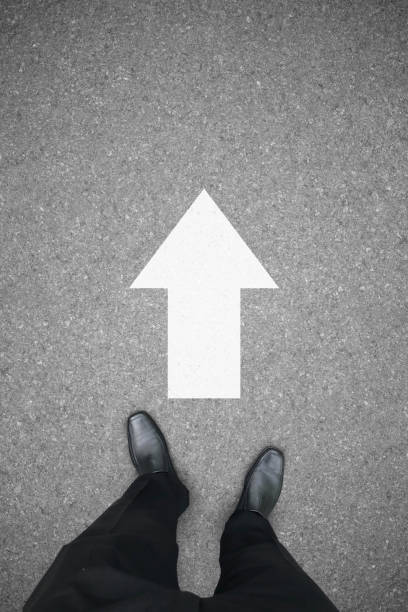 istock Businessman and direction sign to go ahead forward 1055924158