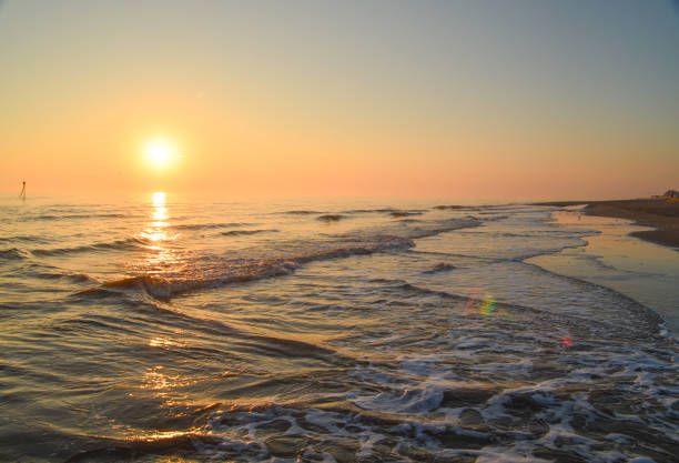 Sunrise on beautiful beach with waves