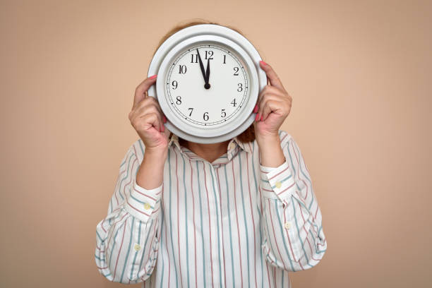 istock Woman with a big clock 1055927810