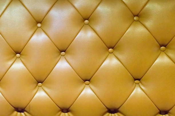 istock Beige genuine leather upholstery, closeup.Background and texture with Leather for sofa. 1055927960
