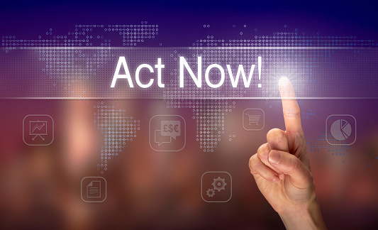 A hand selecting an Act Now business concept on a clear screen with a colorful blurred background.