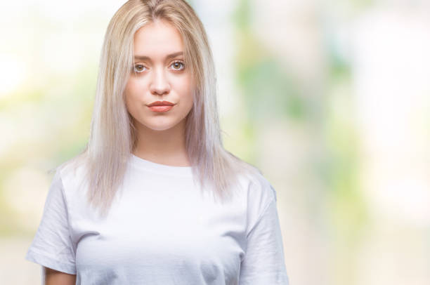 istock Young blonde woman over isolated background with serious expression on face. Simple and natural looking at the camera. 1055930292