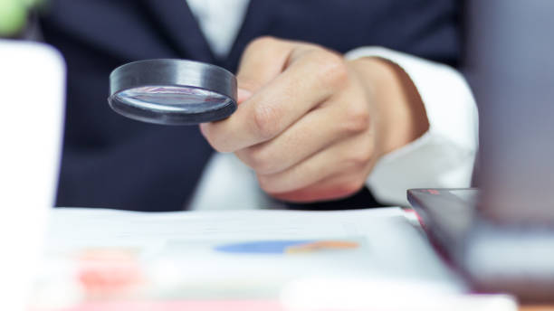 istock Businessmen use a magnifying glass to analyze the company's data and statistics from the chart. 1055935056