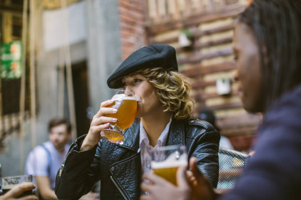 istock Women drinking beer in a bar 1055936510
