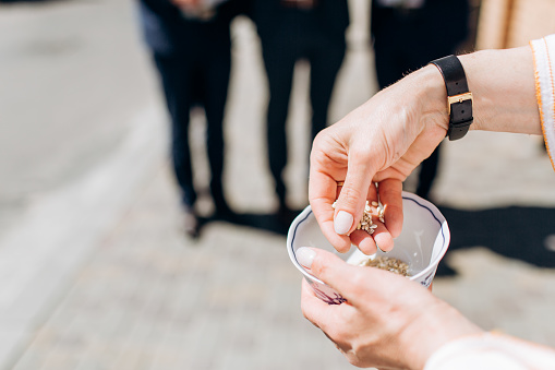 https://media.istockphoto.com/id/1055938496/photo/closeup-of-man-holding-rice-bowl-to-throw-at-married-couple-old-european-wedding-tradition.jpg?b=1&s=170667a&w=0&k=20&c=XBMUKKGAyGzI2Wb2ZBsmlv52hmQ76nSGJMmn73clffg=