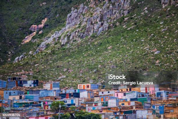 Shack Homes In Township Below Massive Mountain In Kleinmond Western Cape South Africa Stock Photo - Download Image Now