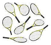 3d rendering many identical tennis racquets hanging at different angles on white background.