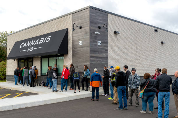Waiting In Line To Buy Legal Cannabis In Canada Saint John, New Brunswick, Canada - October 17, 2018: People line up to purchase cannabis legally from a Cannabis NB store on the first day of legalization in Canada. cannabis store photos stock pictures, royalty-free photos & images
