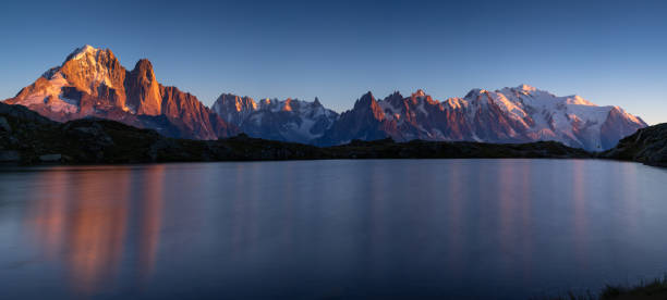 Last light Panorama of the Alps near Chamonix, with Aiguille Verte, Auguille du Midi and Mont Blanc, during sunset at Lac des Cheserys. aiguille de midi photos stock pictures, royalty-free photos & images