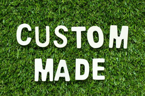 istock Alphabet letter in word custom made on artificial green grass background 1055944612