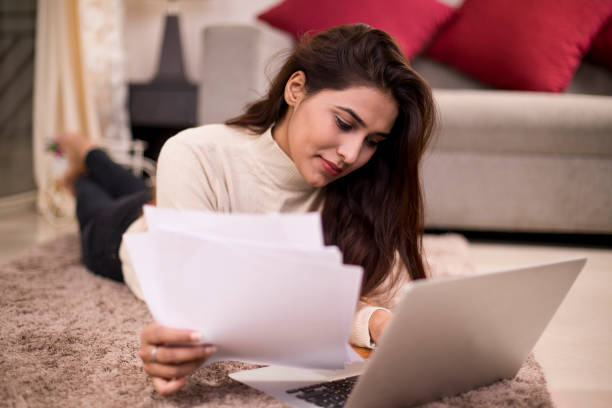 istock Woman using laptop at home 1055945112