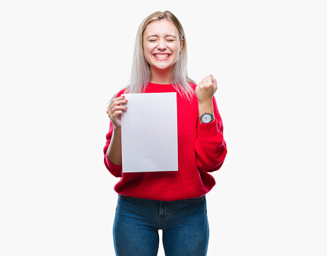 Young blonde woman holding blank paper sheet over isolated background screaming proud and celebrating victory and success very excited, cheering emotion