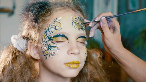 istock Make-up artist make the girl face art. 1055949590
