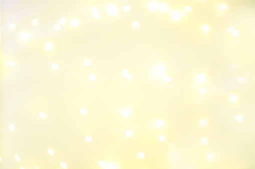 Goldn  Lights Festive background. Abstract Christmas twinkled bright background with bokeh defocused yellow lights