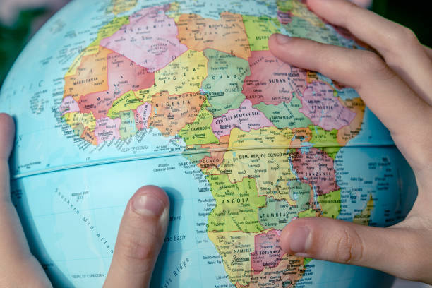 Girls Hands And The Globe Globe in the Girls Hands while she looking for her travel desitation at Africa continent. topographic map photos stock pictures, royalty-free photos & images