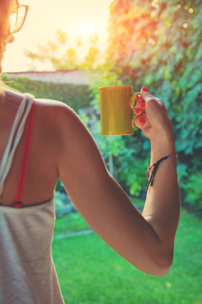 istock Girl drinking coffee / tea in the garden. 1055954006