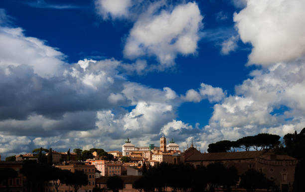 Panoramic view of Capitoline Hill ancient monuments with beautiful clouds above from Circus Maximus, in the historic center of Rome
