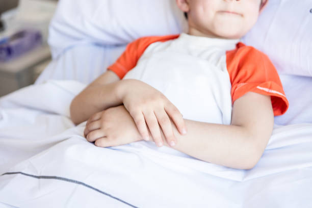 istock Unrecognizable little boy hospitalized lying down on bed 1055957372
