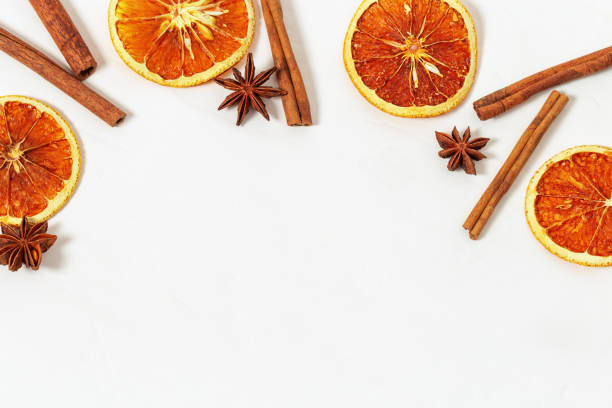 istock Cinnamon sticks, anise stars, dried oranges on light concrete. Frame from spices for mulled wine. Flat lay, top view, copy space. 1055959060