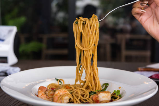istock Spaghetti with spicy prawn in white dish. 1055959512
