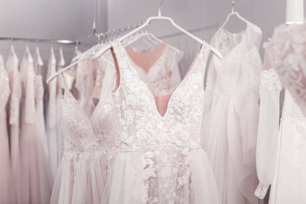 Close up of a beautiful new wedding dress Beautiful design. Close up of a beautiful new wedding dress hanging on the hanger in the wedding boutique bridal shop photos stock pictures, royalty-free photos & images