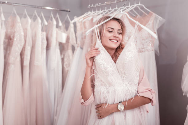 istock Joyful nice woman standing with a wedding dress 1055961776