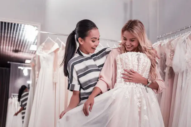 Photo of Happy nice women finding a wedding dress