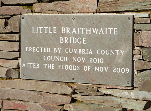 A plaque on the new stone bridge over Newlands Beck at Little Braithwaite in the English Lake District after the floods of 2009. UK.