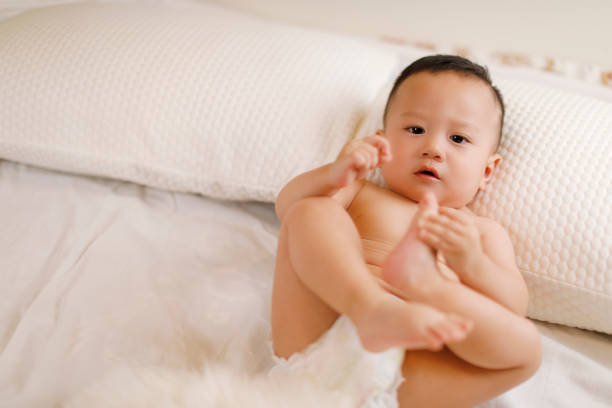 istock Cute baby on the white bed 1055966772