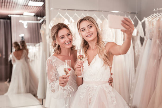 istock Joyful positive brides taking a selfie together 1055968158