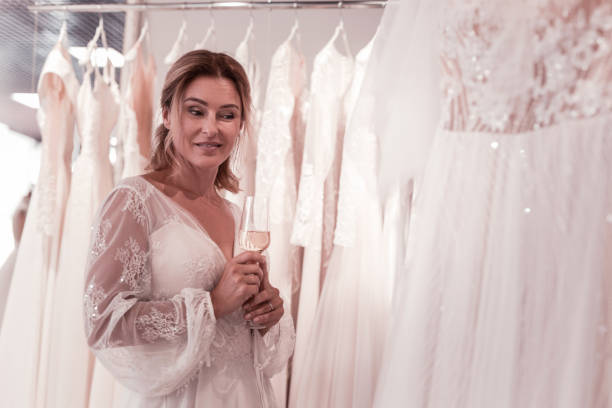istock Nice happy woman choosing a wedding dress 1055968192
