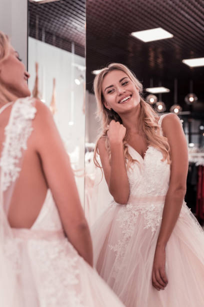 istock Joyful beautiful woman looking at her reflection 1055968234