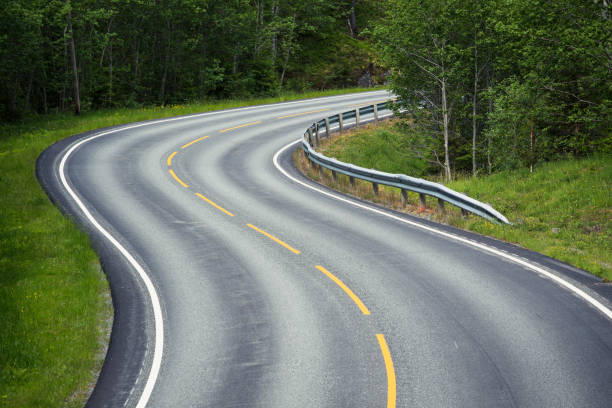 istock empty winding forest road at the mountains