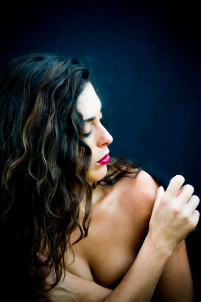 istock Beautiful woman on black background 1055970578