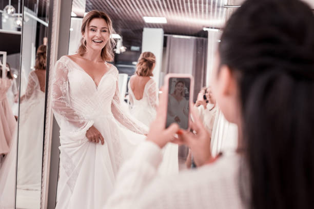 istock Delighted nice woman looking into the smartphone camera 1055971308