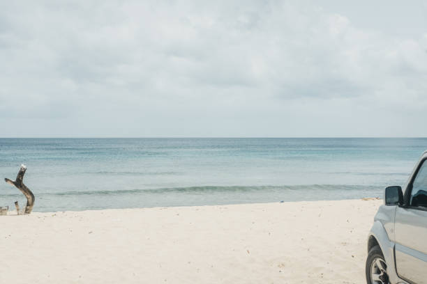 istock Unidentified car parked on a beach in Barbados. 1055975072