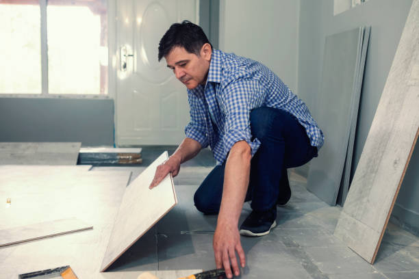istock Carpenter installing a wooden flooring 1055980260