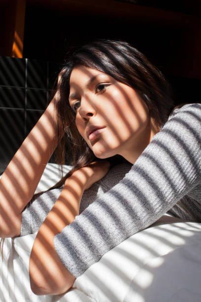 istock Woman smiling in her bed 1055982726