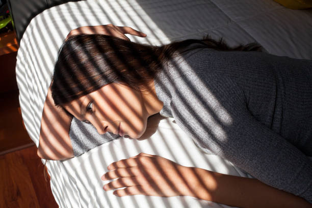 istock Woman smiling in her bed 1055982806