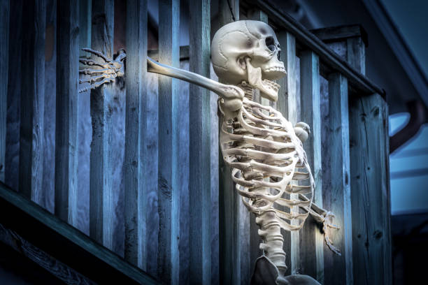 istock Halloween scary skeleton hanging on balcony. 1055985638
